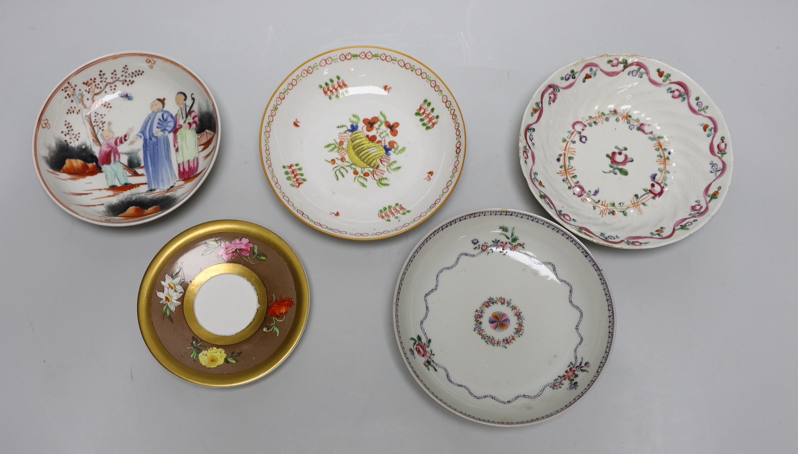 A group of early 19th century English porcelain cups and various saucers to include a Spode two handled chocolate cup and saucer (10)